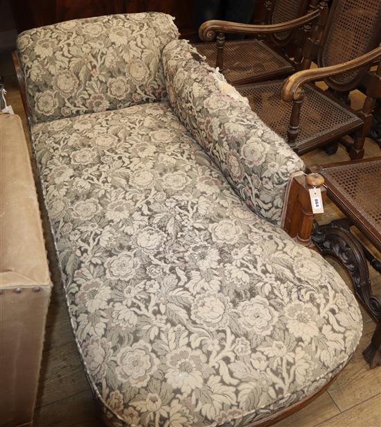 A Victorian oak upholstered chaise longue